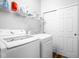 Functional laundry room equipped with modern washer, dryer, and ample storage shelving at 5864 Mustang Ter, Plainfield, IN 46168