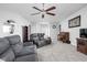 Large living room featuring a ceiling fan, plush carpet, comfortable seating and ample natural light at 5864 Mustang Ter, Plainfield, IN 46168