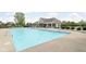 Community pool with lounge chairs offers a refreshing oasis for relaxation and leisure in a serene setting at 5864 Mustang Ter, Plainfield, IN 46168