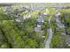 Neighborhood aerial showing homes, a pond, mature trees and lawns at 5925 Silas Moffitt Way, Carmel, IN 46033