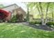 Lush backyard featuring mature trees, landscaping, and a beautifully designed stone patio for outdoor enjoyment at 5925 Silas Moffitt Way, Carmel, IN 46033