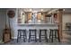 Basement wet bar features a granite countertop, wood cabinets, and slate-look flooring at 5925 Silas Moffitt Way, Carmel, IN 46033