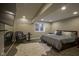Basement bedroom featuring a modern gray comforter, sitting chair, and ample lighting at 5925 Silas Moffitt Way, Carmel, IN 46033