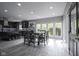 Open-concept dining area with large windows, seamlessly connected to the modern kitchen at 5925 Silas Moffitt Way, Carmel, IN 46033