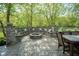 Inviting outdoor fire pit area with built-in seating, stone pillars, and a dining table perfect for gatherings at 5925 Silas Moffitt Way, Carmel, IN 46033