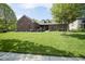 Charming brick home with a lush green lawn and mature trees, offering great curb appeal at 5925 Silas Moffitt Way, Carmel, IN 46033