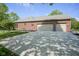 Spacious three-car garage with a wide driveway offering ample parking and convenient access to the brick home at 5925 Silas Moffitt Way, Carmel, IN 46033