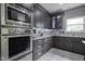 Well-equipped kitchen with stainless steel oven, microwave, and granite countertops at 5925 Silas Moffitt Way, Carmel, IN 46033