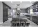 Spacious kitchen boasts an island with seating, modern appliances, and stylish gray cabinetry at 5925 Silas Moffitt Way, Carmel, IN 46033