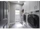 Bright laundry room features modern washer and dryer with built-in storage at 5925 Silas Moffitt Way, Carmel, IN 46033
