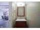 Elegant powder room boasts a decorative framed mirror and a stylish vanity with a modern faucet at 5925 Silas Moffitt Way, Carmel, IN 46033