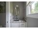 Charming powder room featuring a granite countertop, modern faucet, and window with natural light at 5925 Silas Moffitt Way, Carmel, IN 46033