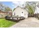 Backyard with a deck, table, seating, and a view of the house and fenced yard at 6167 Ralston Ave, Indianapolis, IN 46220