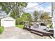 The backyard features a deck, table and chairs, garage, and a grassy area with a fire pit at 6167 Ralston Ave, Indianapolis, IN 46220
