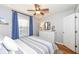Bedroom with hardwood floors, white dresser and blue curtains at 6167 Ralston Ave, Indianapolis, IN 46220