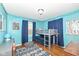 Bedroom with a bunk bed, hardwood floor, and blue walls at 6167 Ralston Ave, Indianapolis, IN 46220
