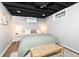 Finished basement bedroom featuring a queen size bed and painted ceiling at 6167 Ralston Ave, Indianapolis, IN 46220