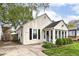 Cozy home with bright siding, black shutters, a sunroom, well-maintained landscaping, and a lush front lawn at 6167 Ralston Ave, Indianapolis, IN 46220