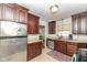 View of kitchen with stainless steel refrigerator, wooden cabinets, and tile floor at 6167 Ralston Ave, Indianapolis, IN 46220