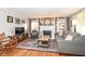 Cozy living room with fireplace, gray couch, sitting chair, wooden floors and decor at 6167 Ralston Ave, Indianapolis, IN 46220
