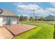 Wooden deck in the backyard with a pergola, offering ample space for outdoor relaxation and entertainment at 623 White Ash Trl, Mooresville, IN 46158