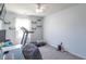 Bedroom including treadmill, shelving, a desk area, and a brightly lit window at 623 White Ash Trl, Mooresville, IN 46158