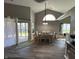 Dining area featuring a modern light fixture, sliding glass door to backyard, and hardwood flooring at 623 White Ash Trl, Mooresville, IN 46158
