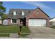 Charming brick home featuring a well-maintained lawn, attached garage, and inviting curb appeal at 623 White Ash Trl, Mooresville, IN 46158