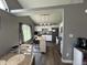 Bright kitchen with a central island, stainless appliances, white cabinets, and a window overlooking the yard at 623 White Ash Trl, Mooresville, IN 46158