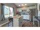 Stylish kitchen island with stainless steel appliances and a large window, perfect for cooking and gathering at 623 White Ash Trl, Mooresville, IN 46158