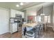 Modern kitchen with an island, stainless steel appliances, and an adjacent dining area, perfect for Gathering meals at 623 White Ash Trl, Mooresville, IN 46158