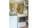 Functional laundry room equipped with a washer, dryer, and organized storage solutions at 623 White Ash Trl, Mooresville, IN 46158