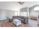 Open-concept living room with a vaulted ceiling, hardwood floors, and a cozy sectional sofa and dining area at 623 White Ash Trl, Mooresville, IN 46158
