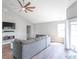 Spacious living room featuring a vaulted ceiling, modern ceiling fan, and a sliding door to the outside at 623 White Ash Trl, Mooresville, IN 46158