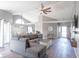 Spacious living room with a vaulted ceiling, wood floors, and a comfortable sectional sofa at 623 White Ash Trl, Mooresville, IN 46158