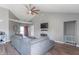 Open-concept living room boasts a vaulted ceiling, modern lighting, and a cozy sectional sofa at 623 White Ash Trl, Mooresville, IN 46158