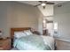 Cozy main bedroom features a soft bedding, a large headboard, and a view into the en-suite bathroom at 623 White Ash Trl, Mooresville, IN 46158