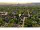 Aerial view of a residential area, showcasing lush green trees, houses, and distant cityscape at 629 N Keystone Ave, Indianapolis, IN 46201