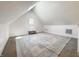 Cozy attic room featuring a light-filled interior, carpet floors, and a stylish gray and white rug at 629 N Keystone Ave, Indianapolis, IN 46201