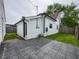 White exterior with a concrete patio and well-maintained grassy backyard, offering a great outdoor space at 629 N Keystone Ave, Indianapolis, IN 46201