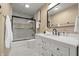 Bathroom with a modern vanity, marble tile accents, and a glass-enclosed shower at 629 N Keystone Ave, Indianapolis, IN 46201