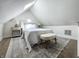 Cozy bedroom featuring neutral tones, a plush rug, and a comfortable upholstered bed under a skylight at 629 N Keystone Ave, Indianapolis, IN 46201