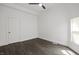 Empty bedroom with a ceiling fan, wood-look flooring, and white walls at 629 N Keystone Ave, Indianapolis, IN 46201