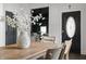 Close-up of a dining table with a decorative vase and a view into the living room at 629 N Keystone Ave, Indianapolis, IN 46201