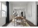 Modern dining room with stylish table and chairs, and an open view to the kitchen area at 629 N Keystone Ave, Indianapolis, IN 46201