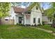 Charming exterior view of a well-kept two-story home with an American flag and manicured lawn at 629 N Keystone Ave, Indianapolis, IN 46201