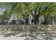 Charming home with a decorative fence and mature tree in the front yard at 629 N Keystone Ave, Indianapolis, IN 46201