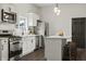 Well-designed kitchen featuring stainless steel appliances, white cabinetry, and a functional island at 629 N Keystone Ave, Indianapolis, IN 46201