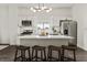 Open concept kitchen with an island featuring barstool seating, stainless appliances, and modern lighting at 629 N Keystone Ave, Indianapolis, IN 46201