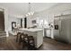 Bright, open kitchen featuring an island, stainless appliances, and seamless access to the dining area at 629 N Keystone Ave, Indianapolis, IN 46201